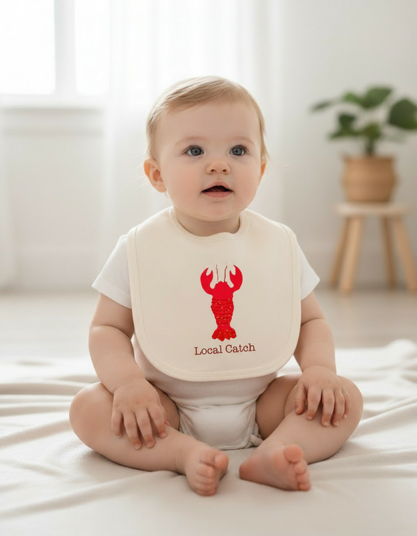 685bf416c0f3f4673dfe2462_white-baby-girl-wearing-lobster-bib-with-white-romper_1763505551317.png